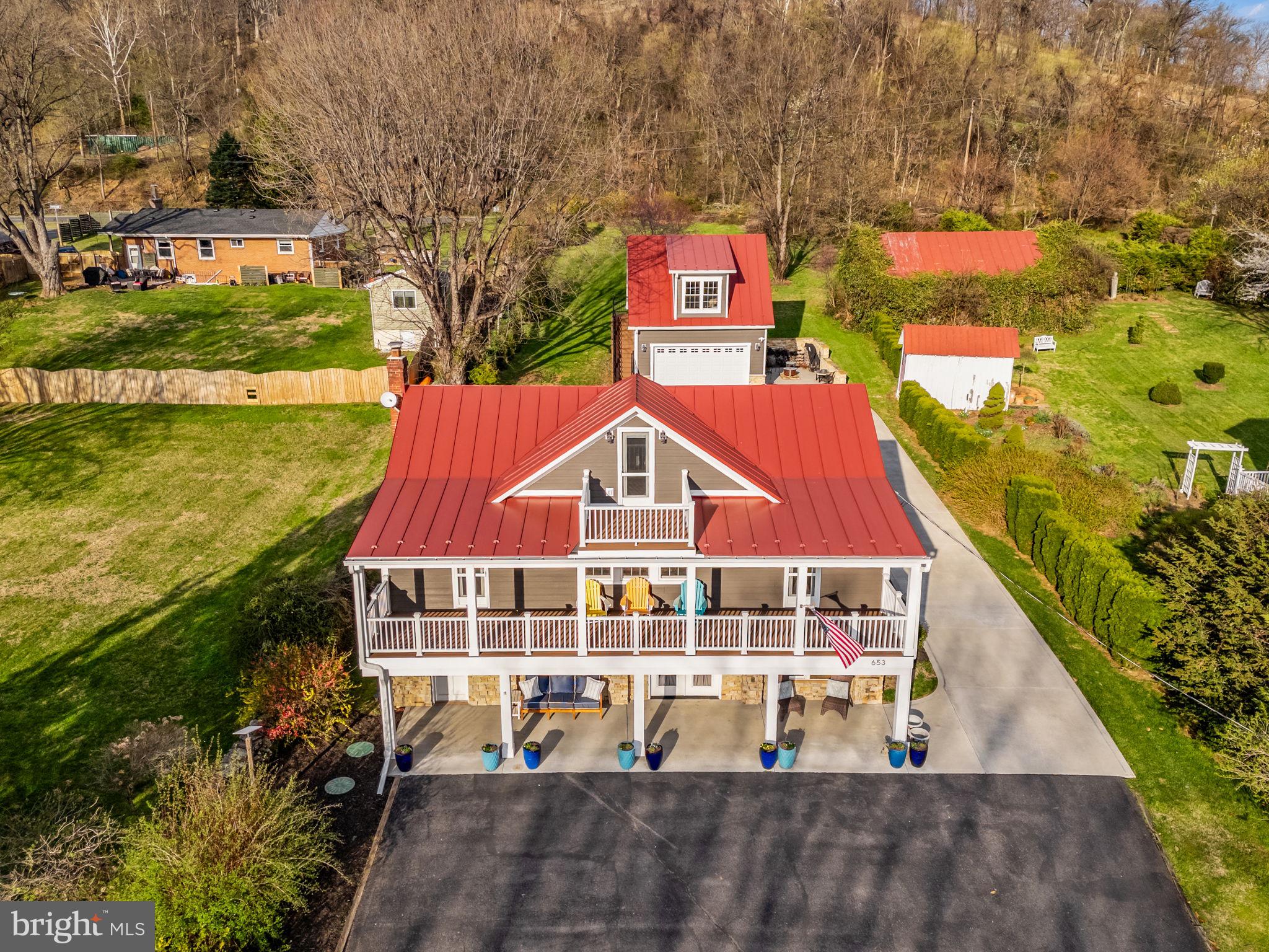 653 Federal Street Paris, VA 20130 - Photo 4 of 64 a front view of a house with a yard swimming pool and outdoor seating