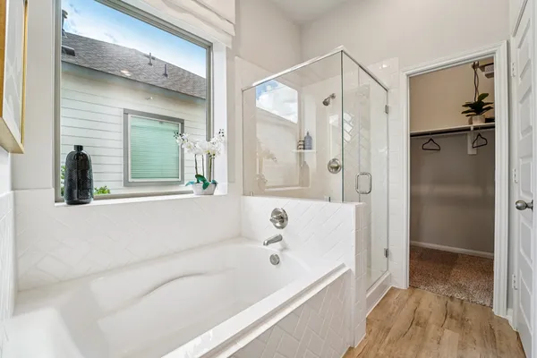 a bathroom with a bathtub and a shower