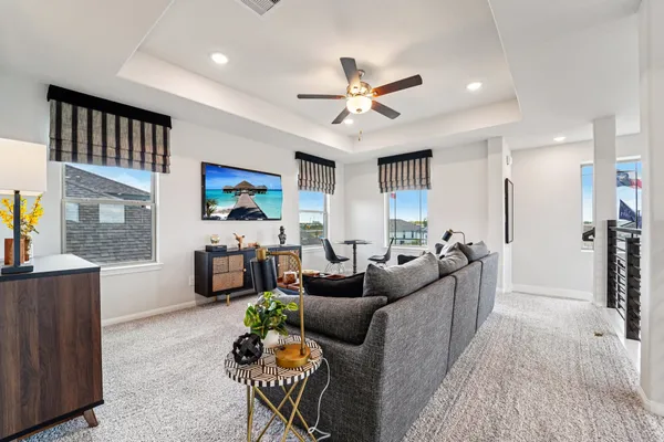 a living room with furniture and a chandelier