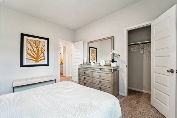 a bedroom with a bed and a dresser