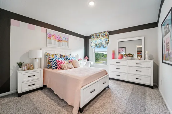 a bedroom with a bed and a dresser