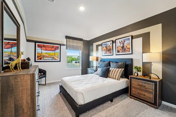 a bedroom with furniture and a flat screen tv