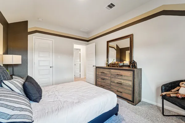 a bedroom with a bed and a dresser