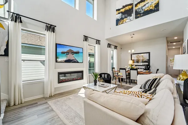 a living room with furniture a fireplace and a flat screen tv