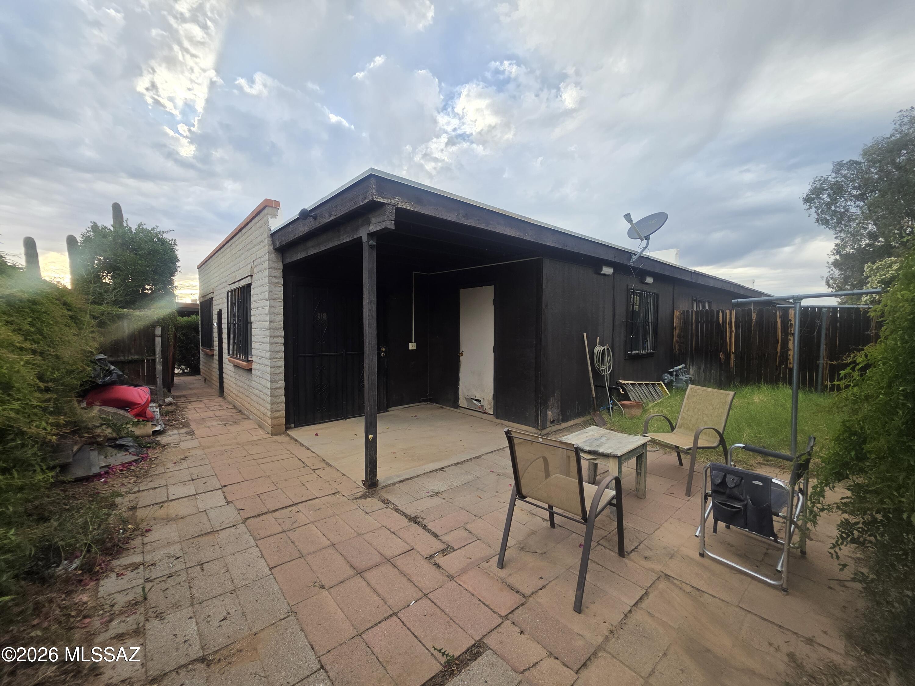 211 West Roger Road, Unit 24 Tucson, AZ 85705 - Photo 5 of 24 a backyard of a house with yard and outdoor seating