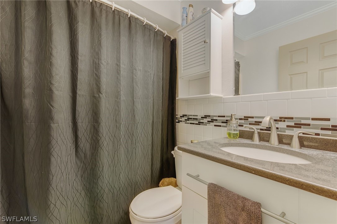 18373 Columbine Road Fort Myers, FL 33967 - Photo 25 of 35 a bathroom with a granite countertop sink and a toilet