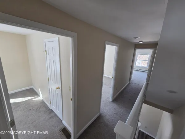 a view of a hallway with windows