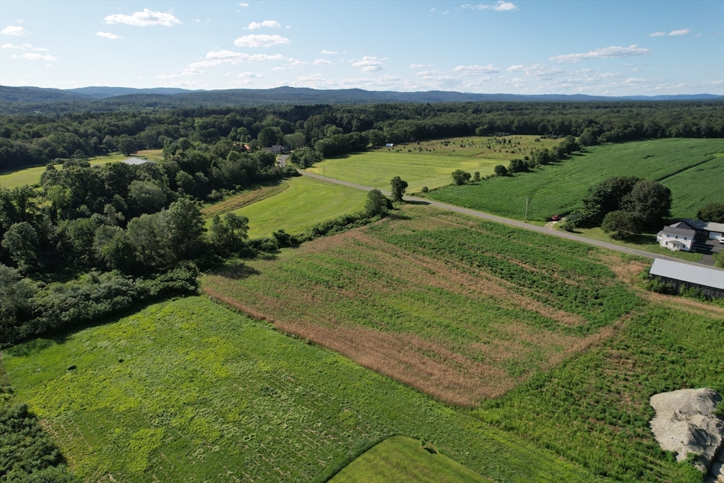0 Depot Road Hatfield, MA 01038 - Photo 2 of 14 an aerial view of green landscape with trees houses and mountain view