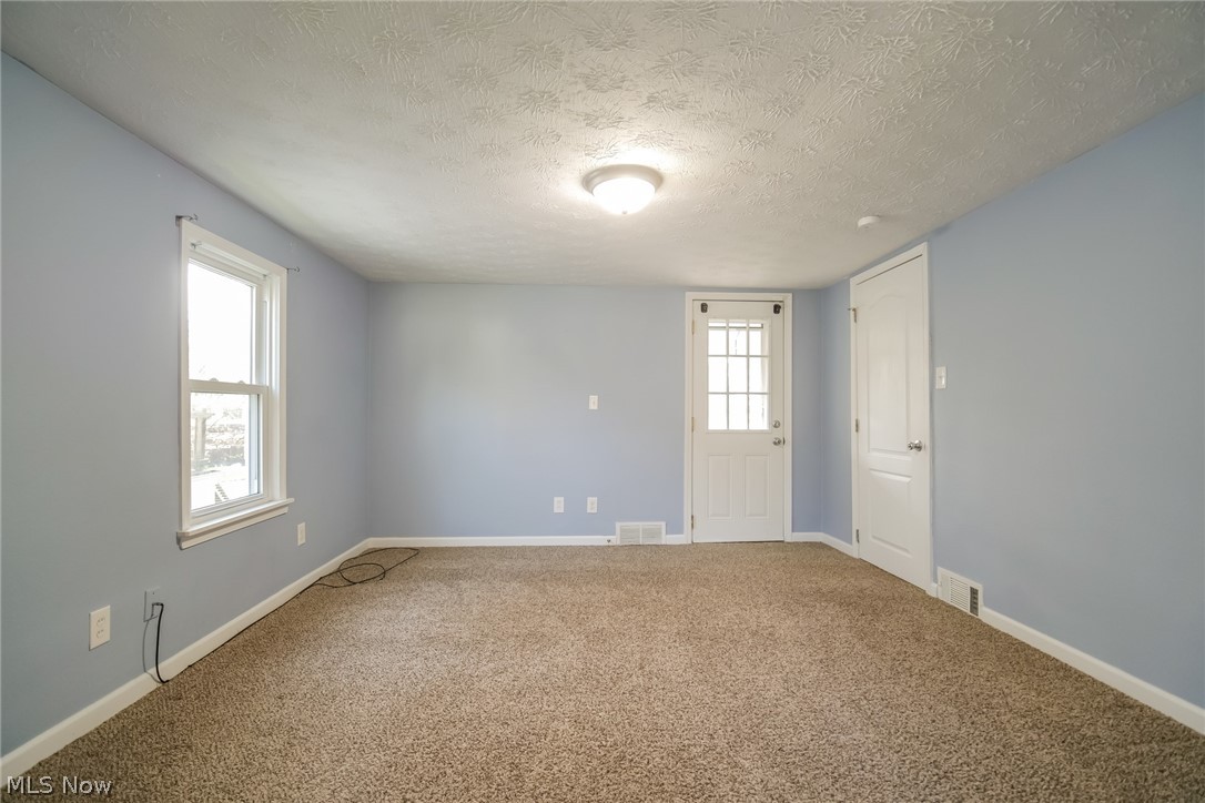 736 Quilliams Road Cleveland Heights, OH 44121 - Photo 16 of 20 Unfurnished room featuring a textured ceiling and carpet floors