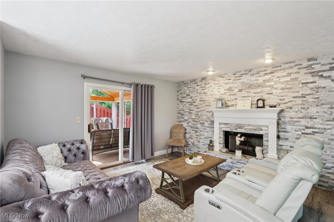 3005 Kent Road Stow, OH 44224 - Photo 8 of 35 Living room featuring a gas fireplace and access to three seasons room