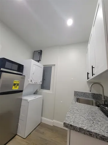 a kitchen with a sink and a stove top oven