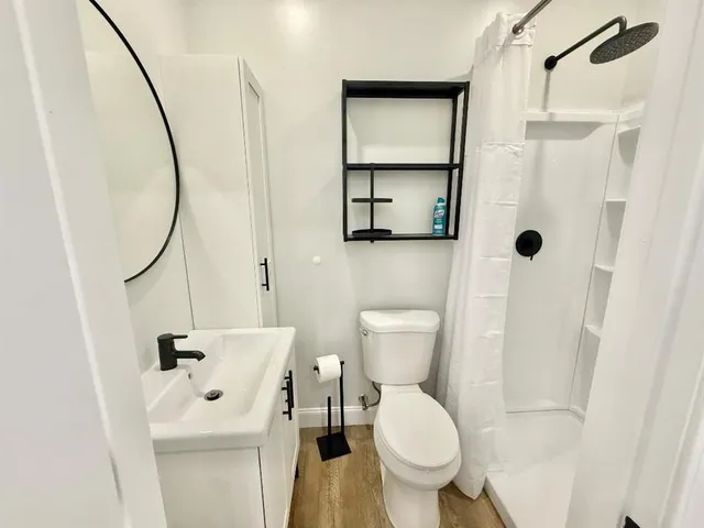 a bathroom with a toilet sink and shower