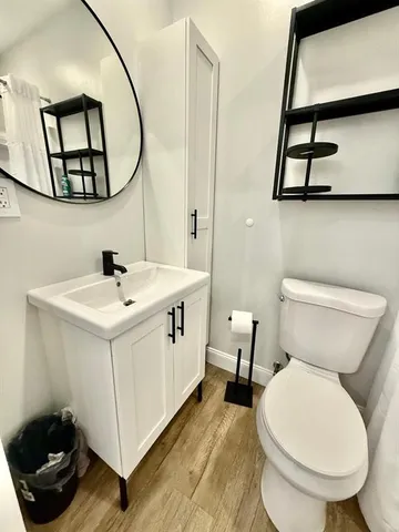 a bathroom with a toilet sink and mirror