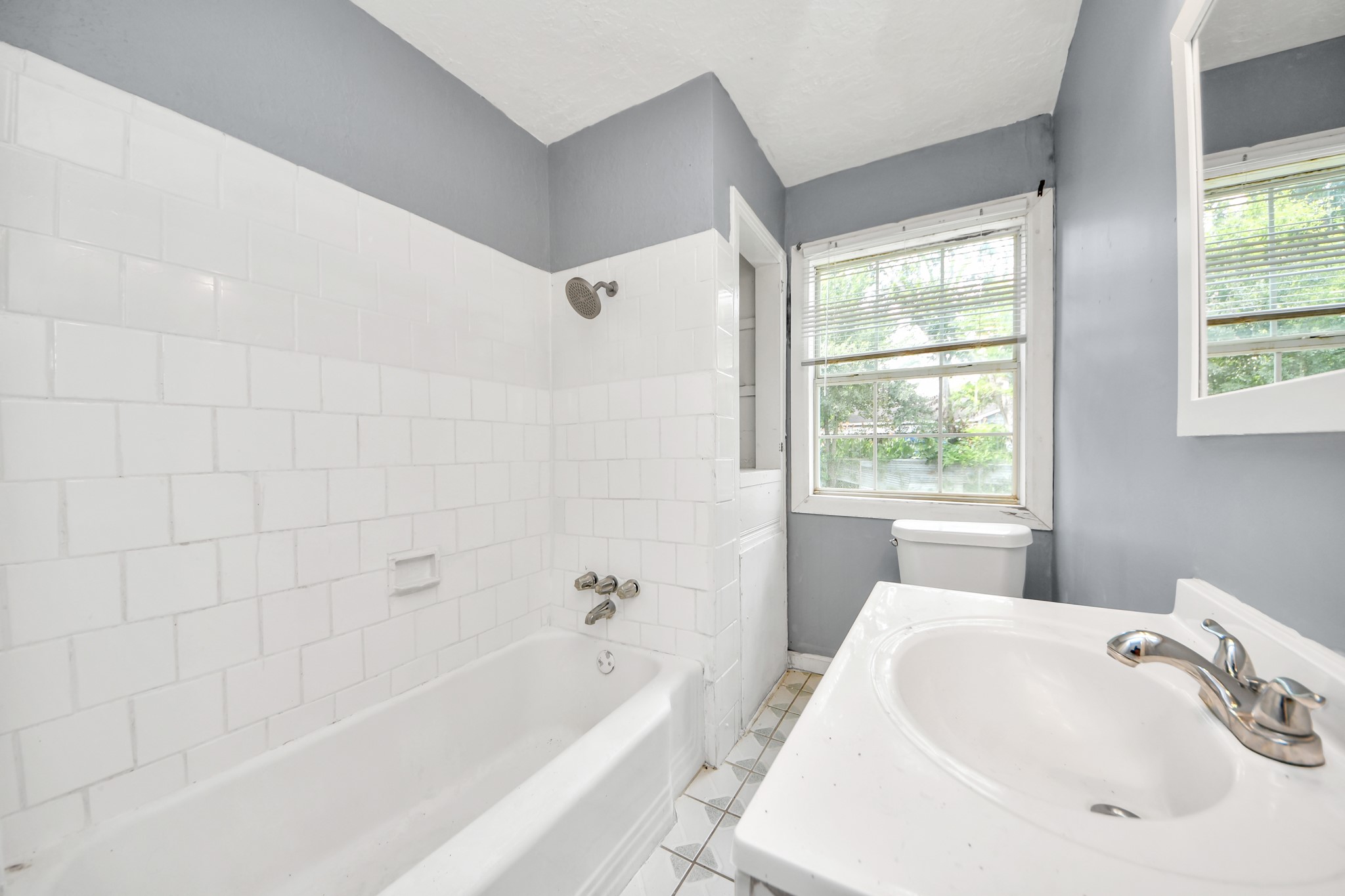 113 Obion Road Houston, TX 77076 - Photo 14 of 22 Sunny bathroom with a soaking tub.
