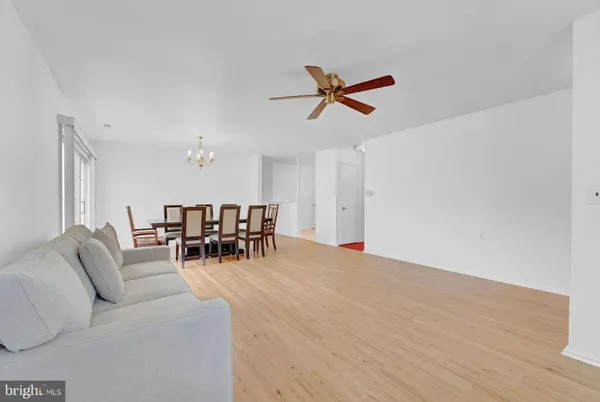 a living room with furniture and a view of dining room