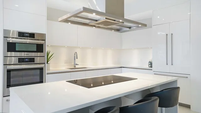 a bedroom with a large bed and a potted plant