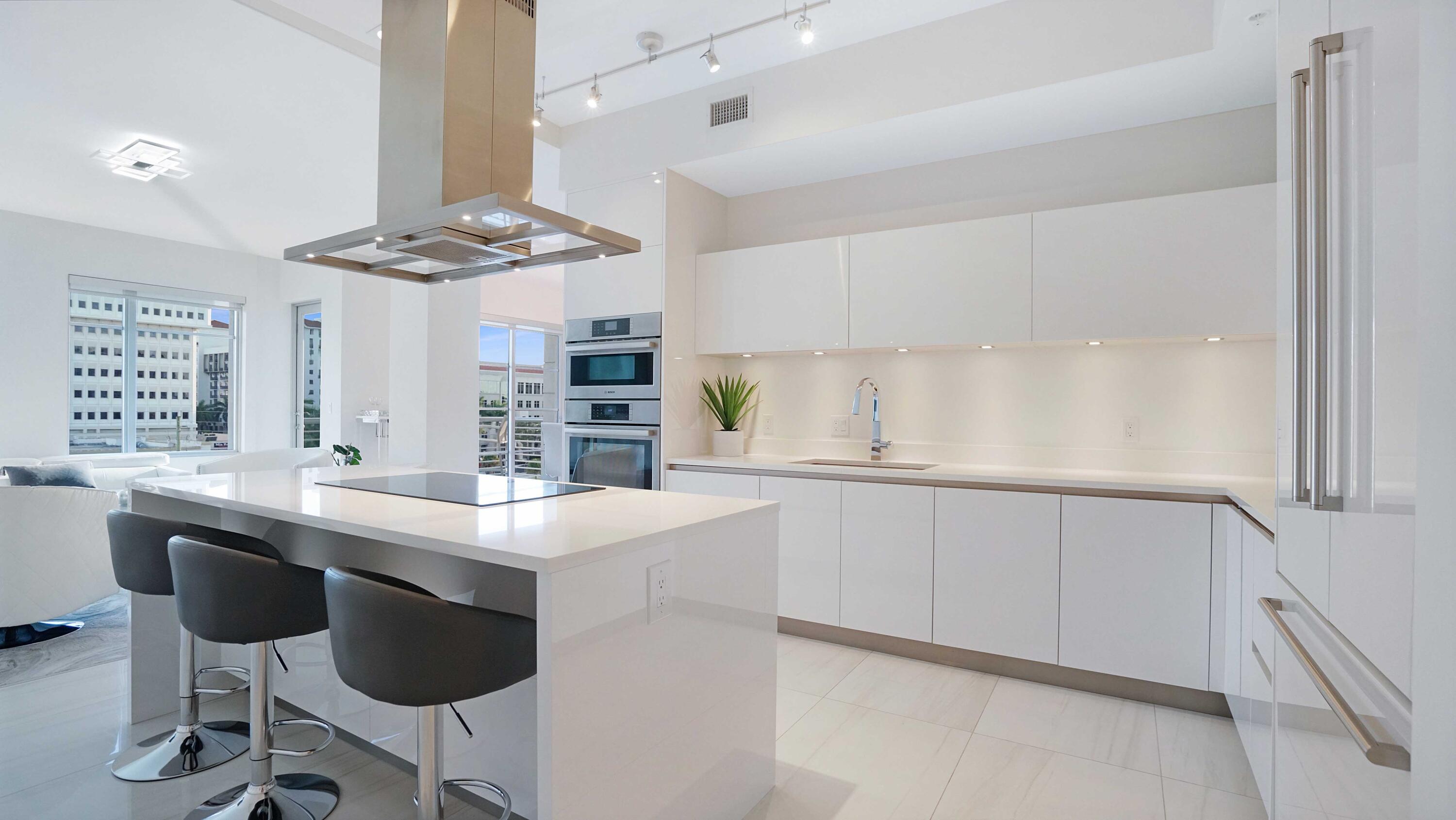 155 East Boca Raton Road, Unit 501 Boca Raton, FL 33432 - Photo 12 of 83 a kitchen with stainless steel appliances kitchen island a table and chair in it