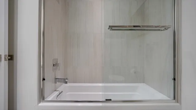 a bathroom with a granite countertop shower and a sink