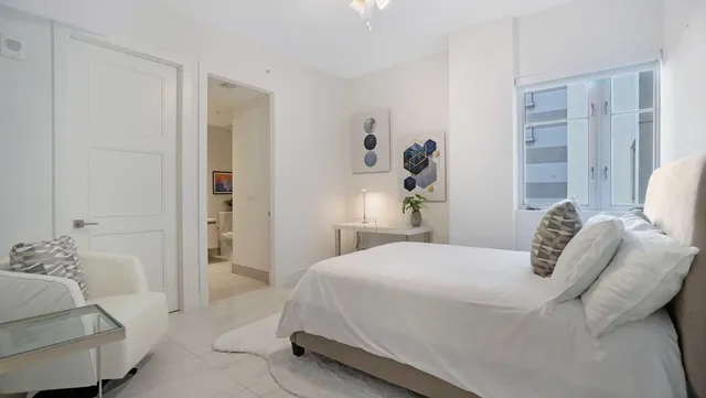 a kitchen with white cabinets and appliances
