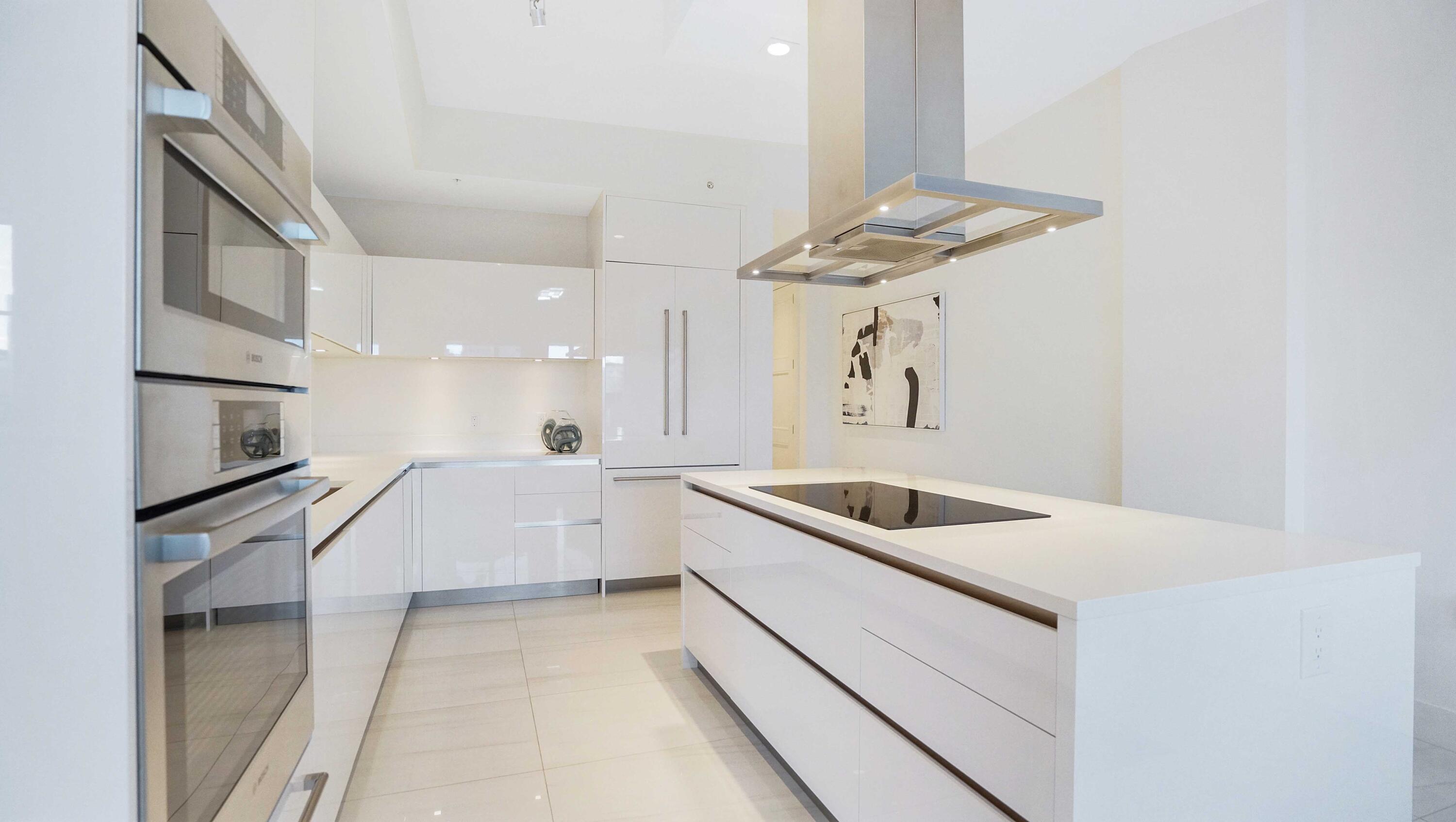 155 East Boca Raton Road, Unit 501 Boca Raton, FL 33432 - Photo 40 of 83 a kitchen with white cabinets and appliances