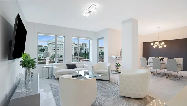 a living room with furniture and a chandelier