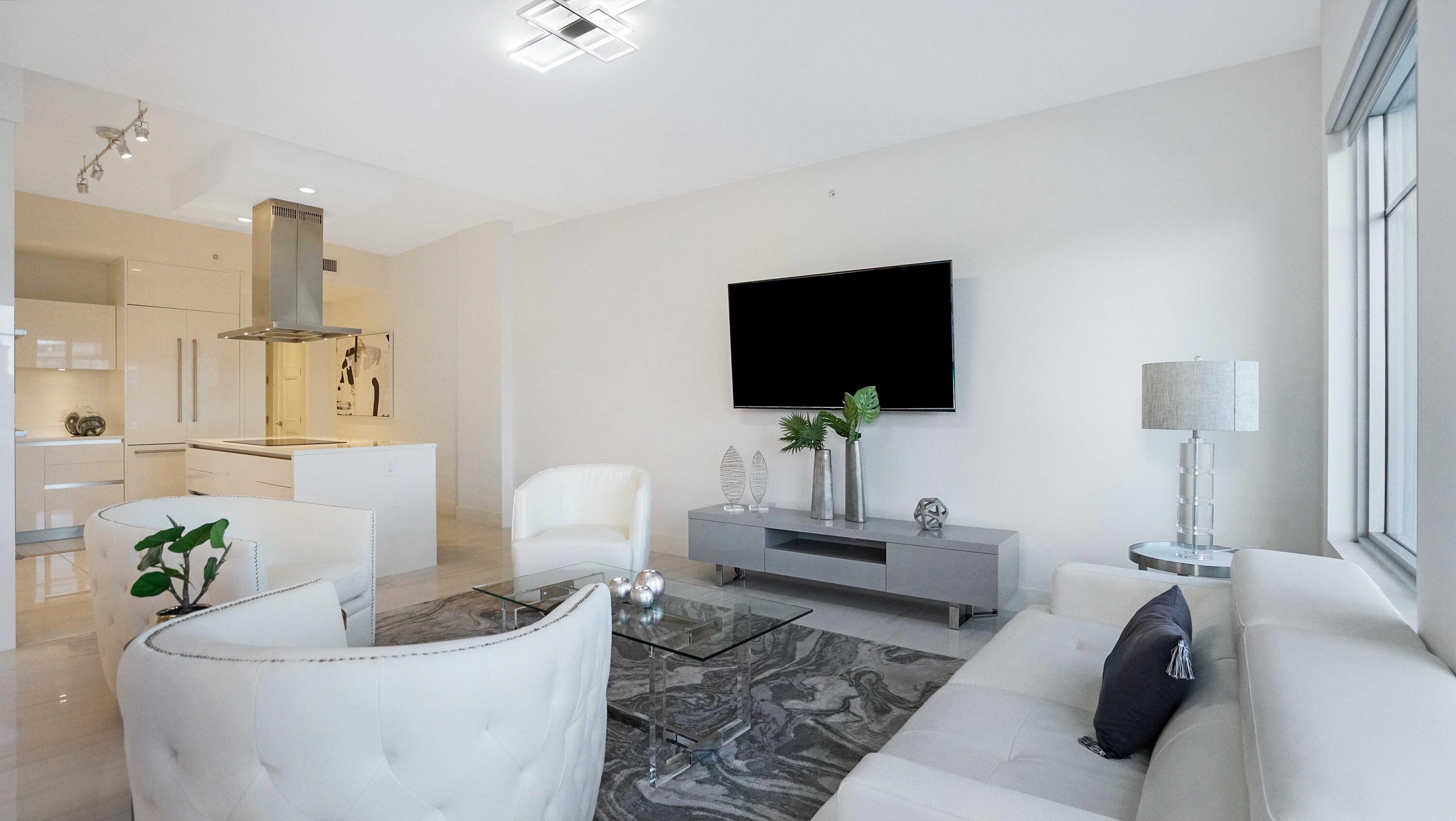 155 East Boca Raton Road, Unit 501 Boca Raton, FL 33432 - Photo 43 of 83 a living room with furniture and a flat screen tv