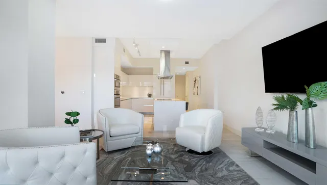 a kitchen with granite countertop a refrigerator and a stove top oven