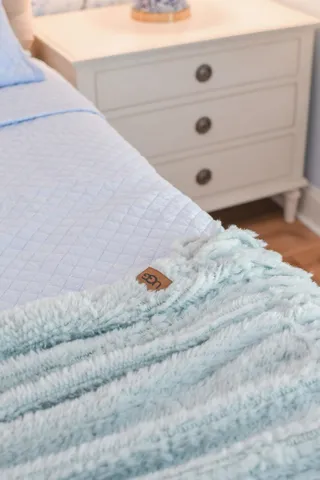 a living room with furniture a flat screen tv and kitchen view