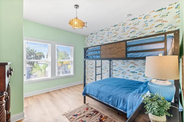 a bedroom with a large bed and a chandelier