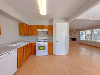 a kitchen with stainless steel appliances granite countertop a stove and a sink