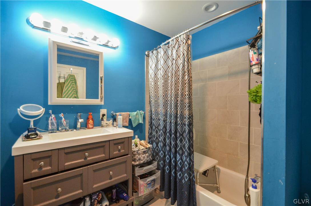 101 Coolbaugh Road East Stroudsburg, PA 18302 - Photo 11 of 24 a bathroom with a sink a mirror and a shower