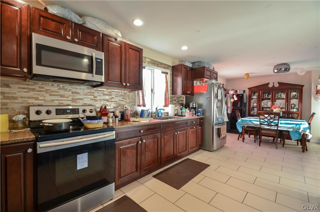 101 Coolbaugh Road East Stroudsburg, PA 18302 - Photo 4 of 24 a kitchen with stainless steel appliances granite countertop a sink dishwasher stove and microwave