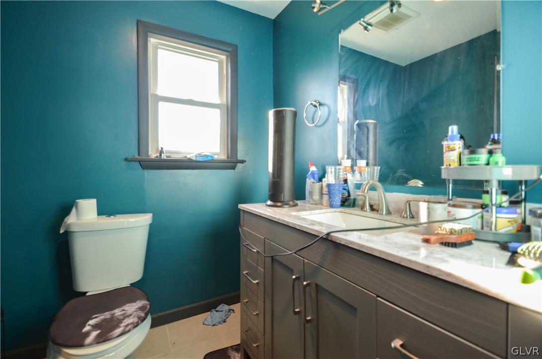 101 Coolbaugh Road East Stroudsburg, PA 18302 - Photo 9 of 24 a bathroom with a sink a toilet a mirror and vanity