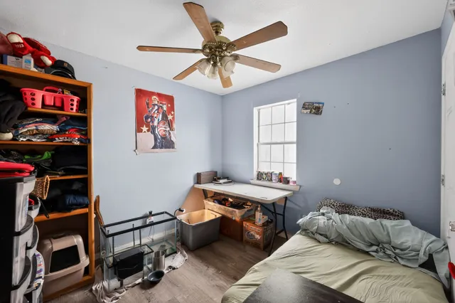 a bedroom with a bed and a bookshelf