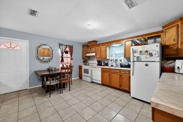 a kitchen with stainless steel appliances granite countertop a refrigerator and microwave