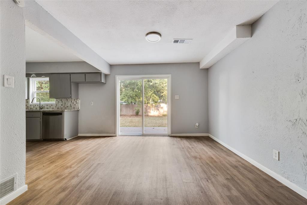 415 Pierce Street Denton, TX 76201 - Photo 4 of 14 a view of an empty room with window and wooden floor