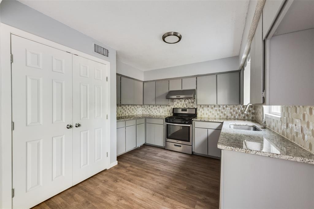 415 Pierce Street Denton, TX 76201 - Photo 6 of 14 a kitchen with granite countertop a sink cabinets and stainless steel appliances