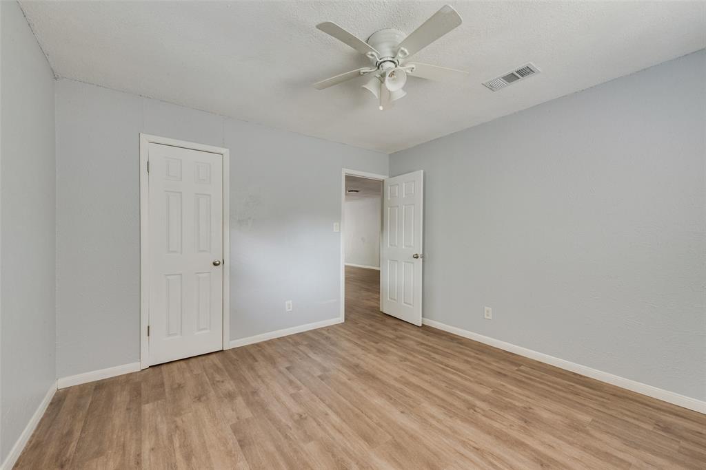 415 Pierce Street Denton, TX 76201 - Photo 9 of 14 a view of an empty room with wooden floor