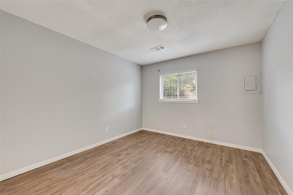 415 Pierce Street Denton, TX 76201 - Photo 10 of 14 an empty room with wooden floor and windows