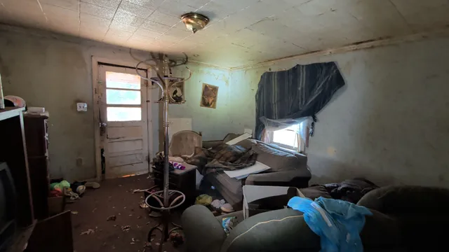 a living room with furniture a window and gym equipment