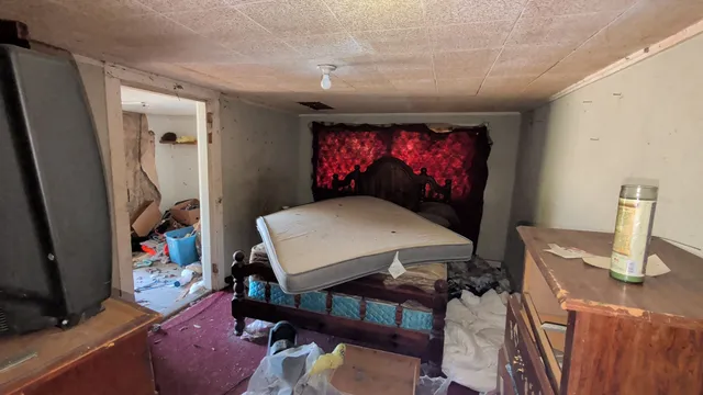 a bedroom with furniture and a flat screen tv