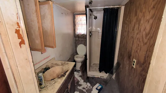 a bathroom with a sink and mirror with bathtub