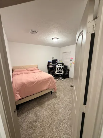 a bedroom with furniture and a mirror