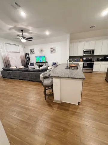 a living room with kitchen island furniture and a kitchen view
