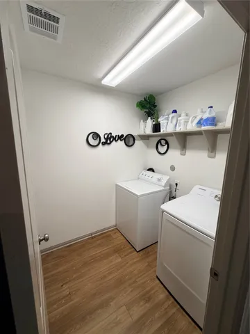 a room with a sink and wooden floor