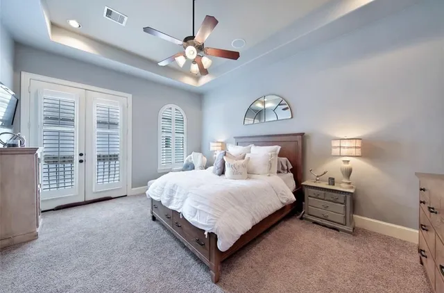 a bedroom with a large bed and a chandelier