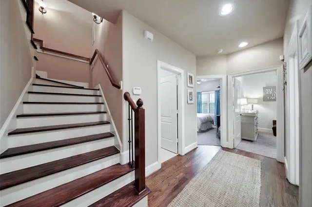 a view of a hallway with a livingroom and stairs