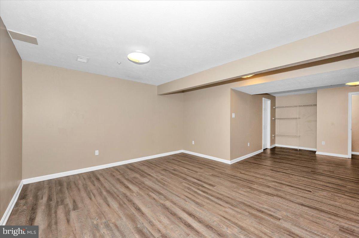 1184 Heathfield Road Sykesville, MD 21784 - Photo 34 of 56 a view of an empty room with wooden floor and a window