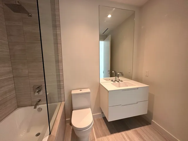 a white toilet sitting next to a bathroom sink