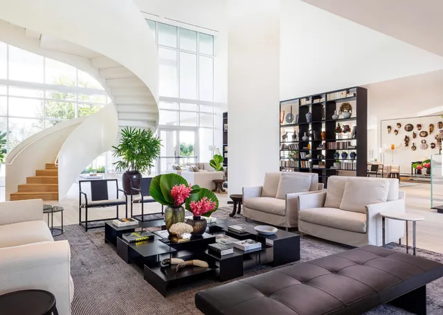 a living room with furniture a rug and a floor to ceiling window